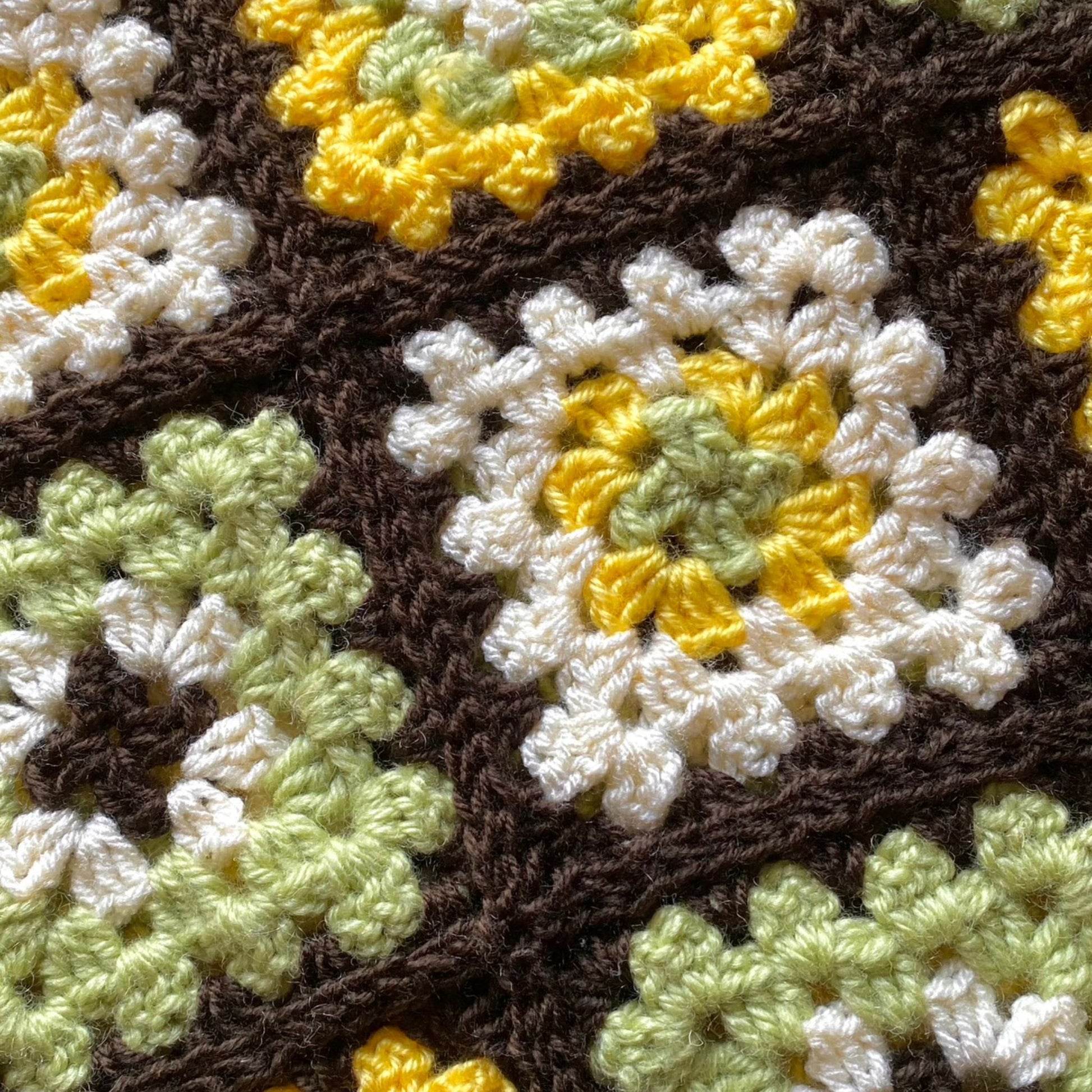 Brown, green, yellow and white crochet granny square skirt